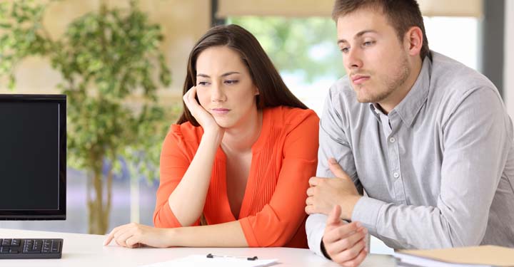 Woman and man sitting next to each other appearing upset