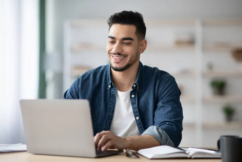 A man looks online for a reputable company that will help him sell his new invention.