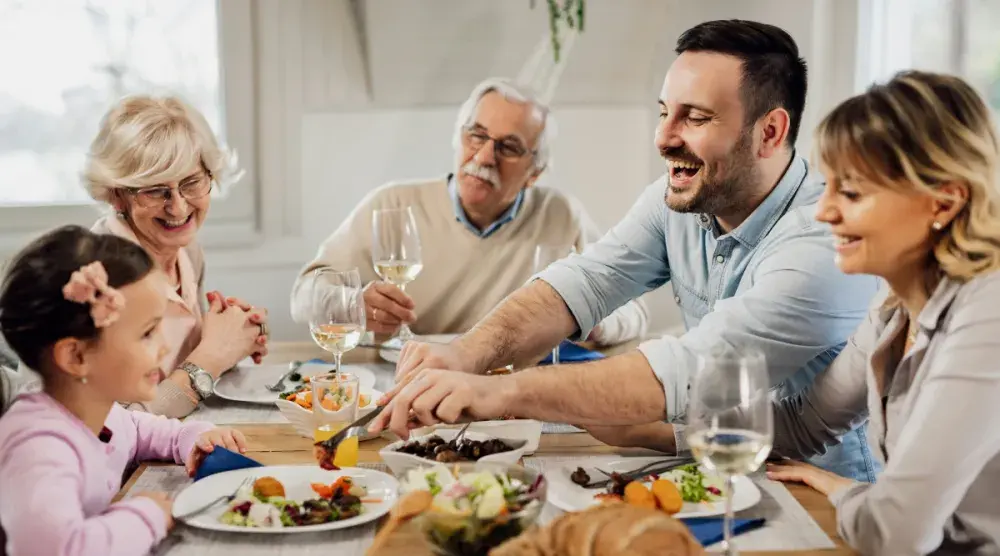 Multigenerational family eating a meal together