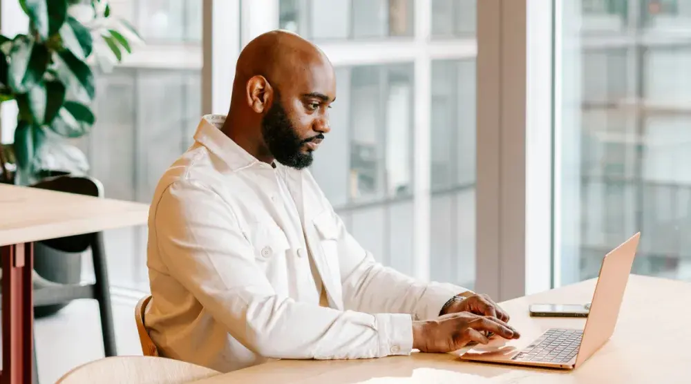 A Kentucky business owner sits at his desk and does a Kentucky business search.