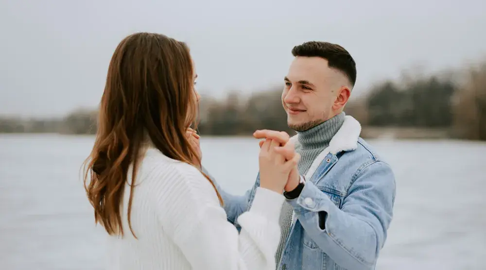 A Texas couple holds hands on a beach and gazes in each other's eyes. It's never too early or too late to consider protecting your assets in the event of a divorce.