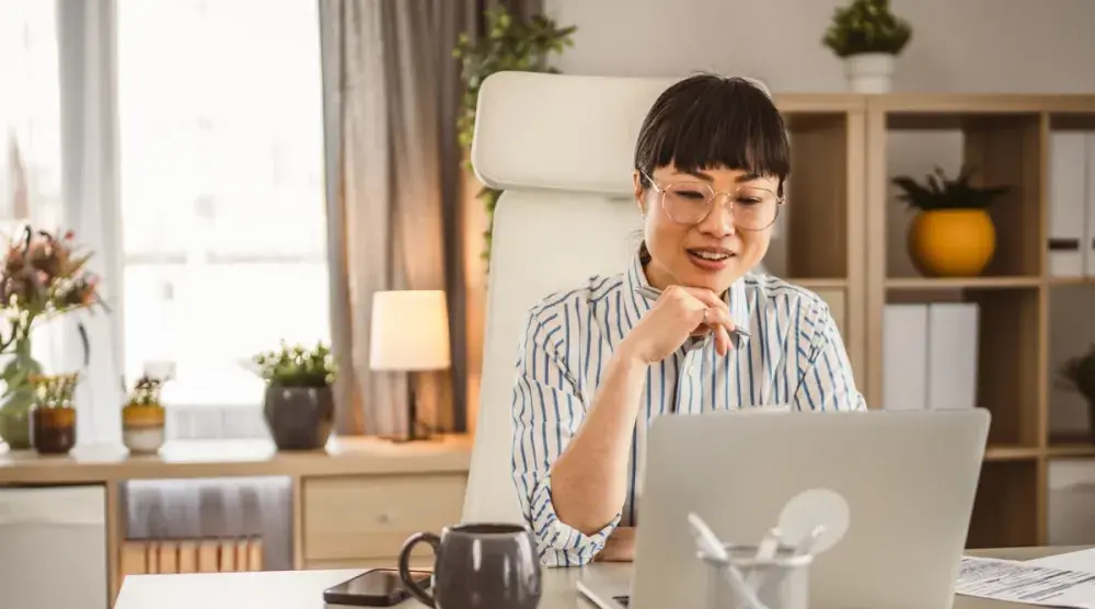 A woman in Pennsylvania sits at her desk in her home office and fills out forms online for her living trust.