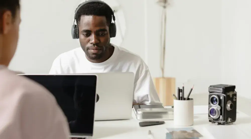 A photography business owner sits in a coworking space and reads over Georgia LLC requirements.