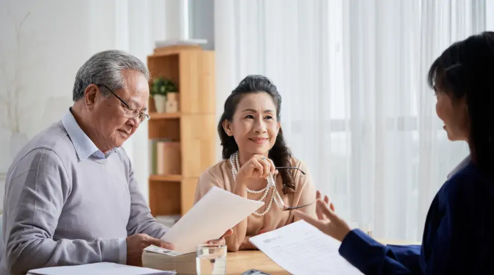 An elderly man and woman in Massachusetts meet with their lawyer to discuss durable power of attorney in their state.