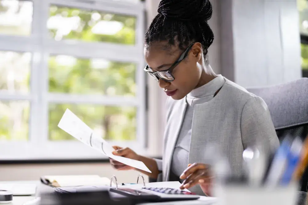 A small business owner looks over her sales receipts.