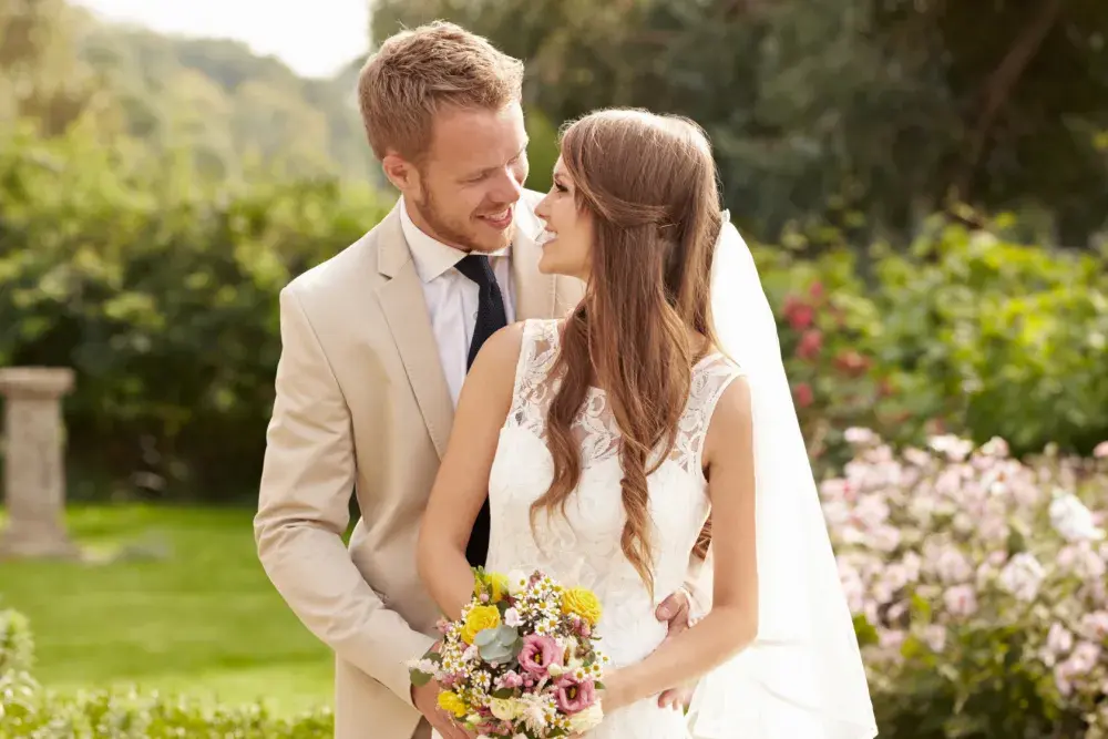 A couple in traditional wedding attire pose for photos.