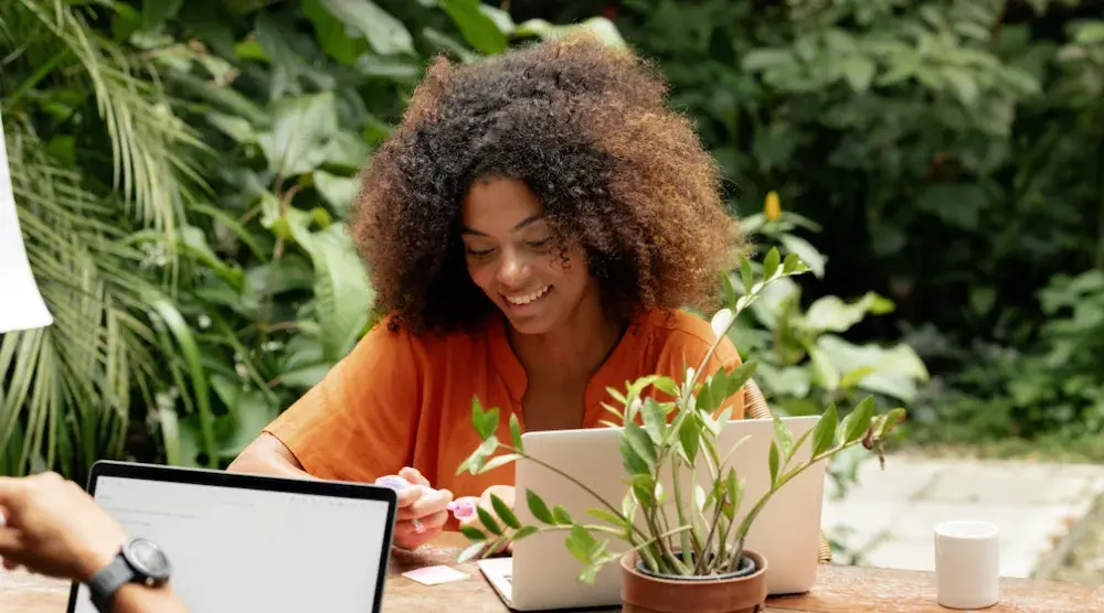 A woman reads about beneficial ownership reporting on her laptop. Business entities such as LLCs and corporations must file a BOI Report unless they fall within one of several exemptions.