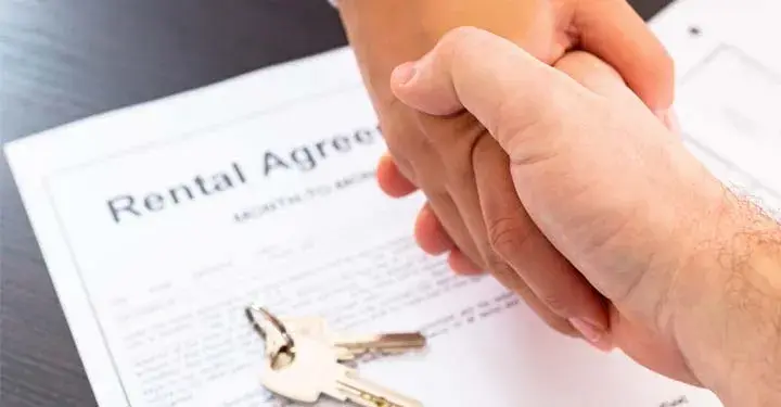 shaking hands over a rental agreement 