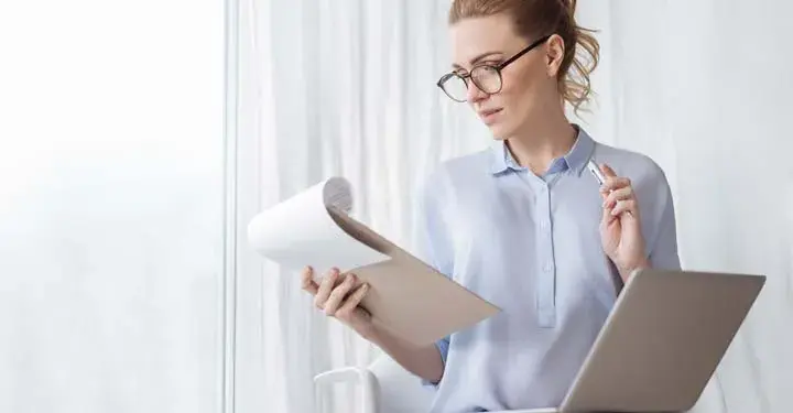 Woman reading from a clipboard