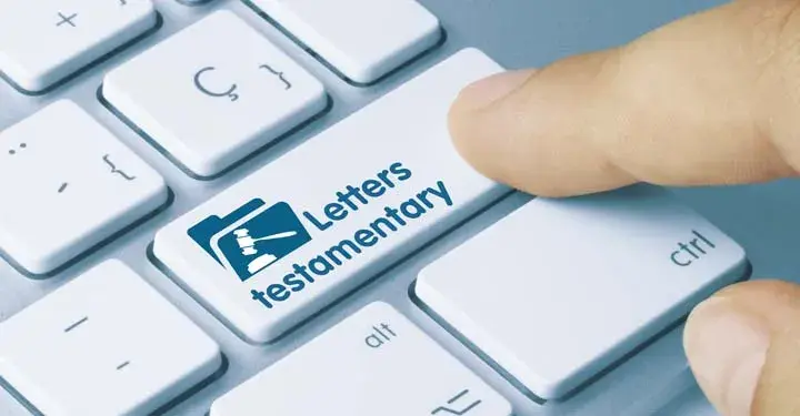 Finger pressing button on computer keyboard which says "letters testamentary" and depicts a gavel and block on a folder