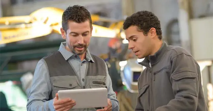 Coworkers looking at a tablet together