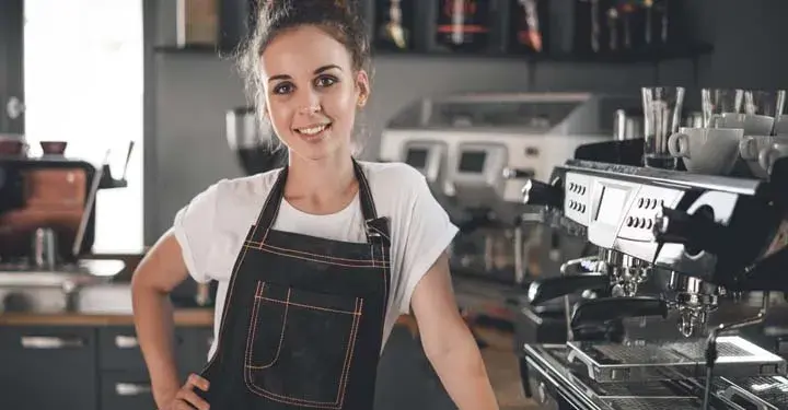 woman standing in front of her counter at her store 