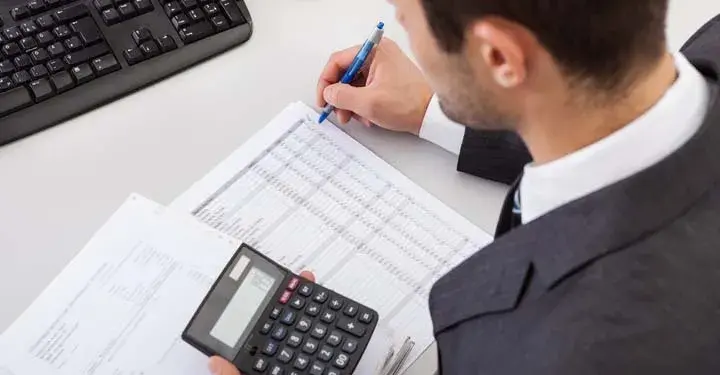 Accountant using a calculator