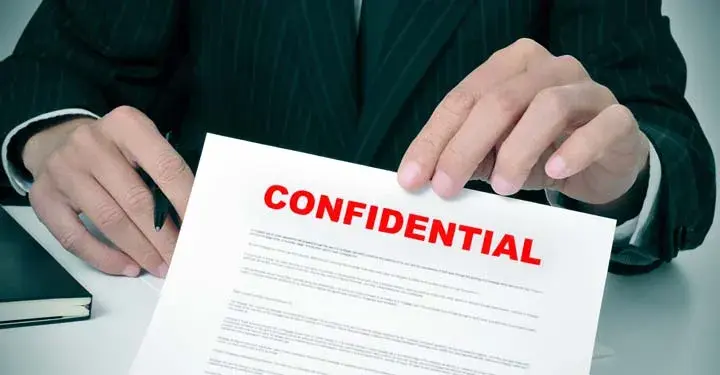 Hands presenting a confidential document