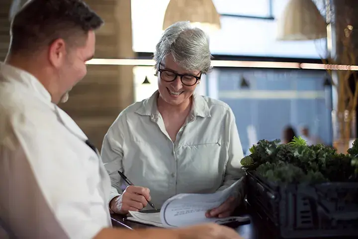 man and woman signing contracts 