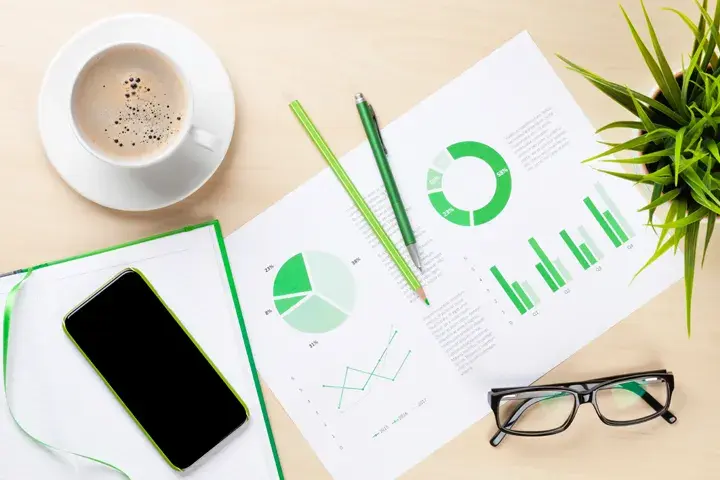 desk with coffee cup and charts