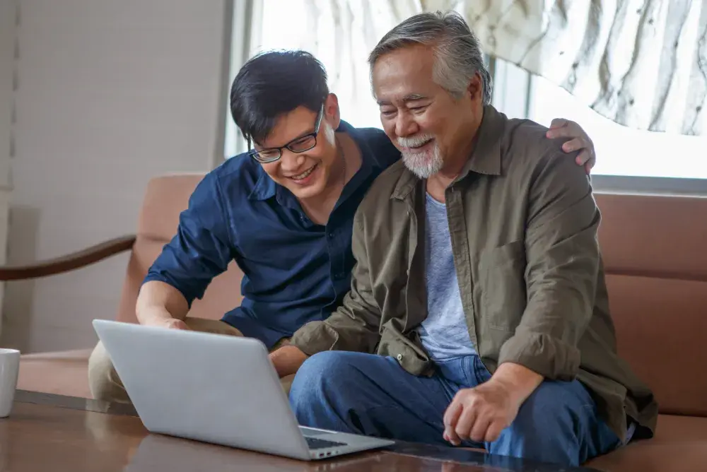 A son helps his father set up a healthcare proxy, also known as a health care power of attorney: online.