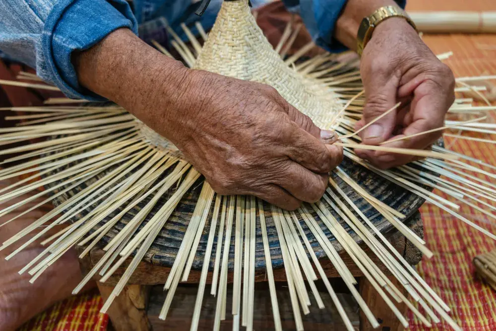 A person weaves a basket while thinking about choosing a unique name for a new California LLC.