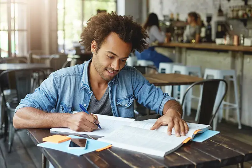 A man writing in a notebook