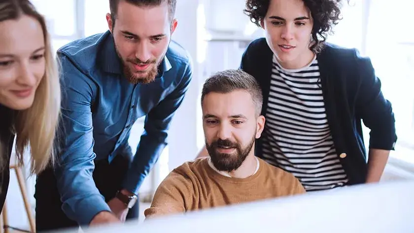 co-workers-look-at-computer-together