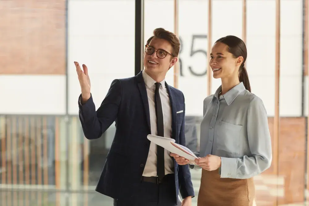 A man and woman visit an empty office space where their California LLC will be based.