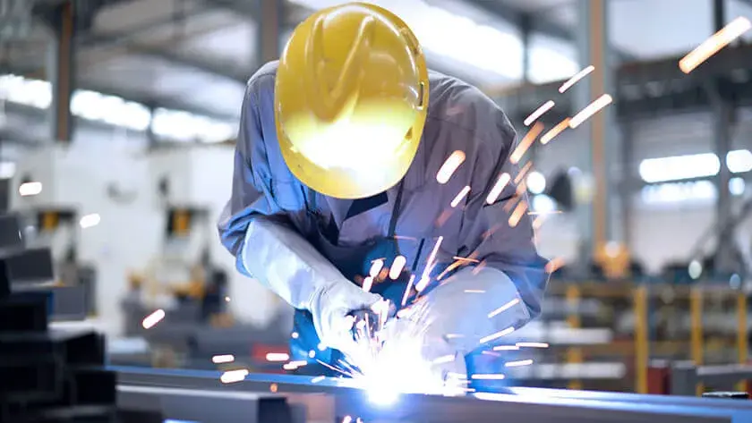 man-welding-wearing-yellow-hard-hat