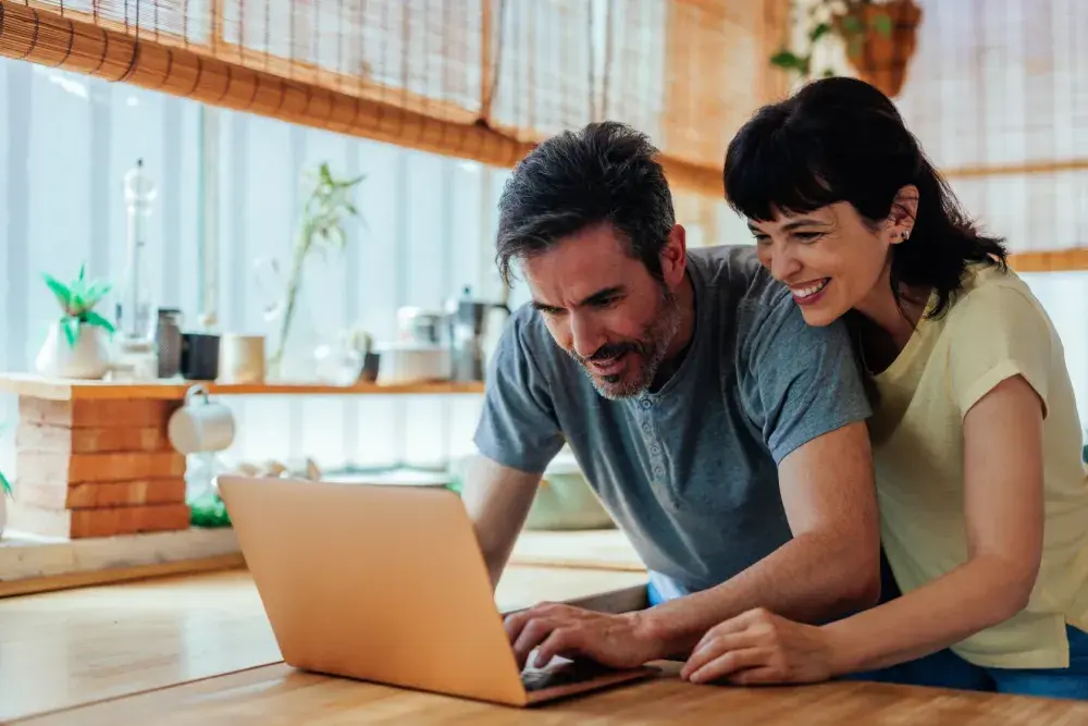 An engaged couple looks up prenuptial agreements online.