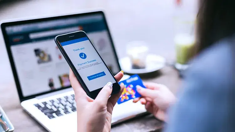 Woman holding phone making an online purchase