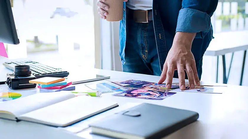 man-reviewing-work-at-desk- with office supplies 