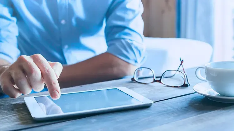 Man using iPad at desk