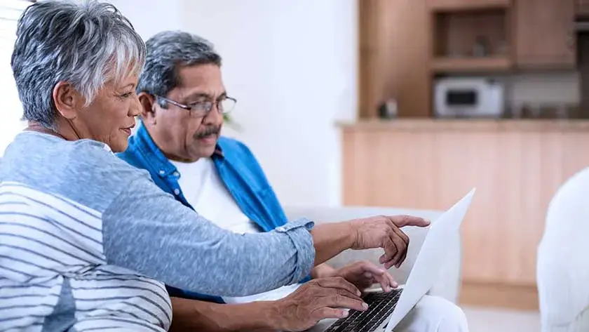 senior-man-woman-looking-at-laptop