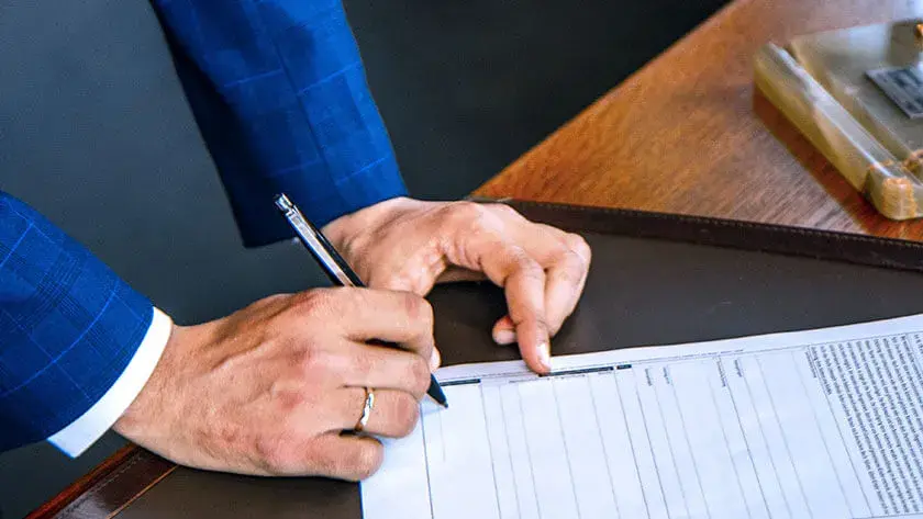 signing-contract-wearing-suit