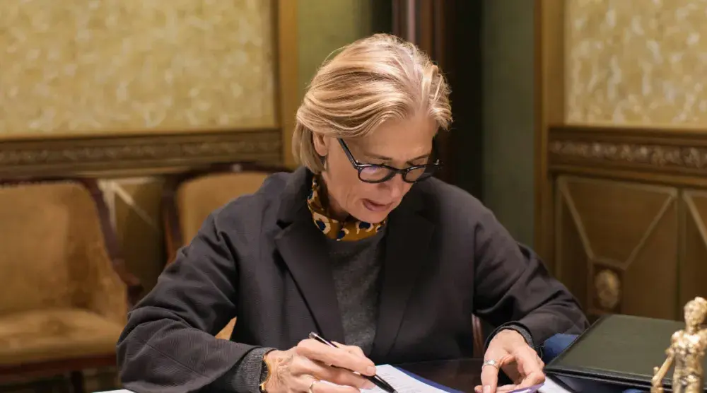 A woman is reading through paperwork trying to understand what type of divorce she qualifies for