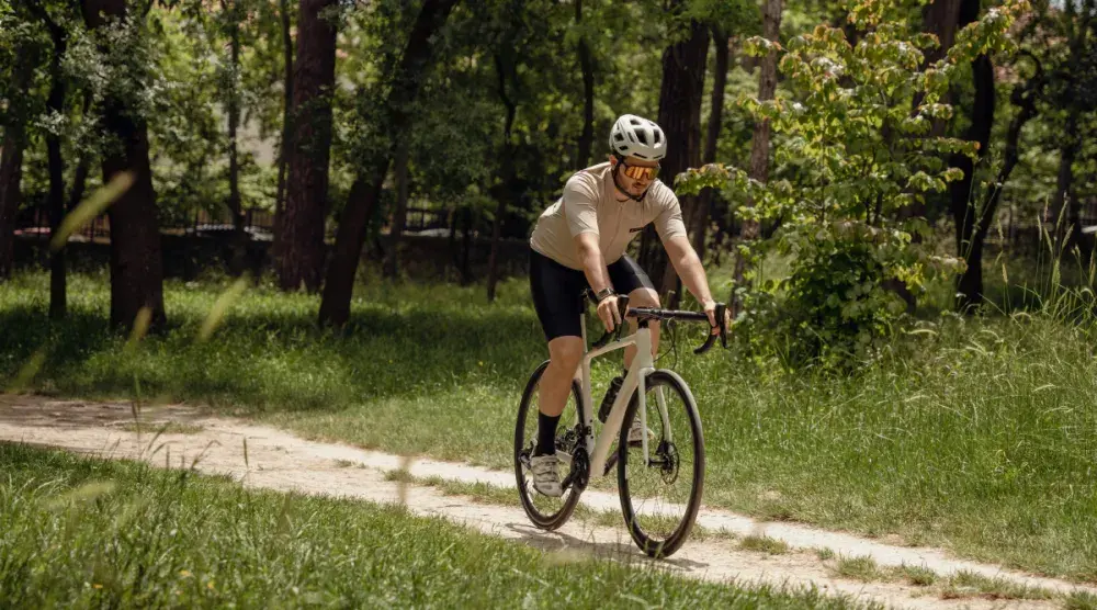 A man wearing a helmet and sunglasses riding a bike who was previously in an accident. He hired a bicycle accident attorney and received compensation.