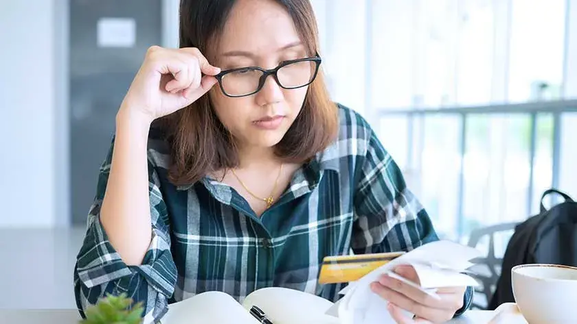 woman-looking-over-receipts as she is thinking about starting a nonprofit 