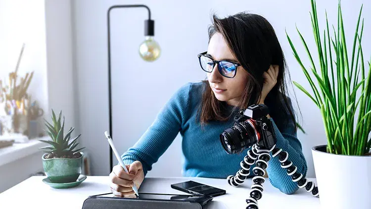 Woman working on iPad at desk