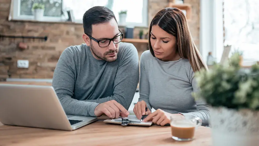 A man and woman examine their living trust documents.