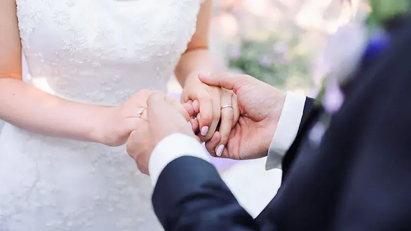 Couple holding hands during wedding ceremony