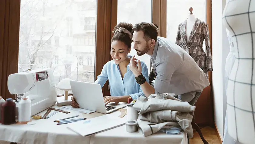 couple looking at laptop in their studio