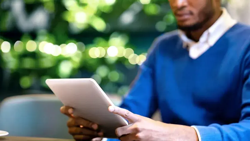 man-looking-at-tablet-outside