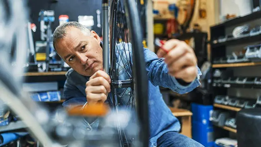 man-repairing-bicycle