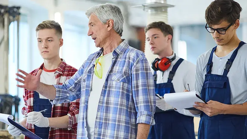 teacher explaining projects to shop class