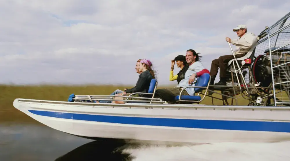 A group of people enjoy a ride on a fast boat. A boat accident lawyer specializes in recovering damages in recreational boating accidents.