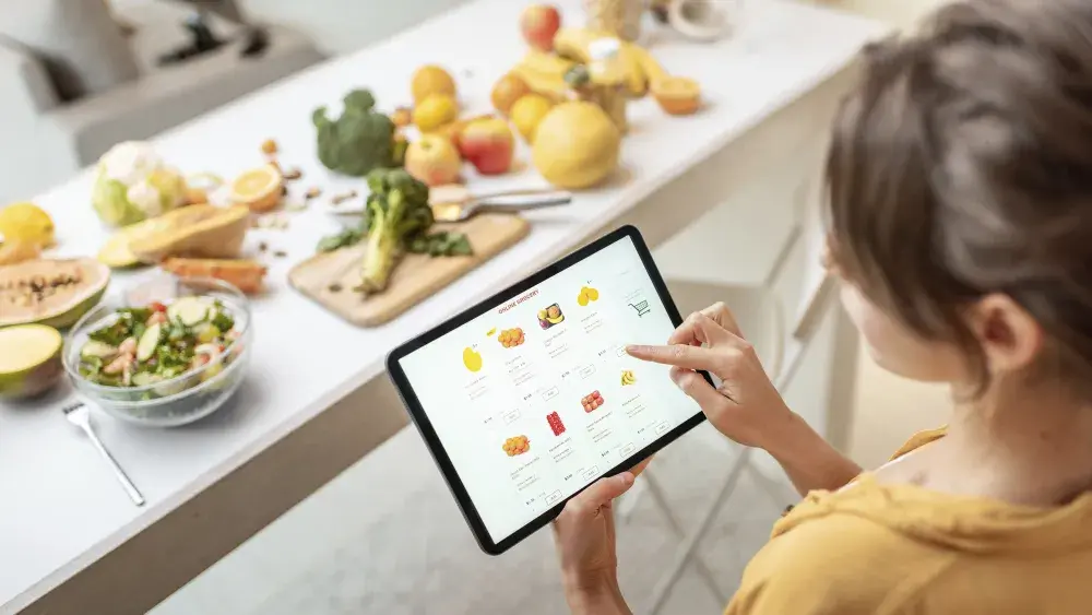 woman looking at recipes on her tablet  