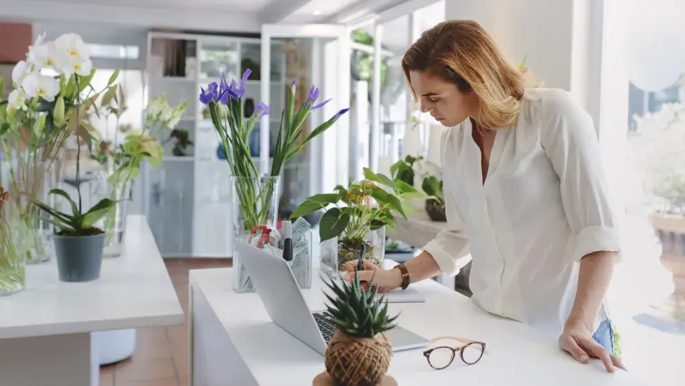 woman on laptop in flower shop