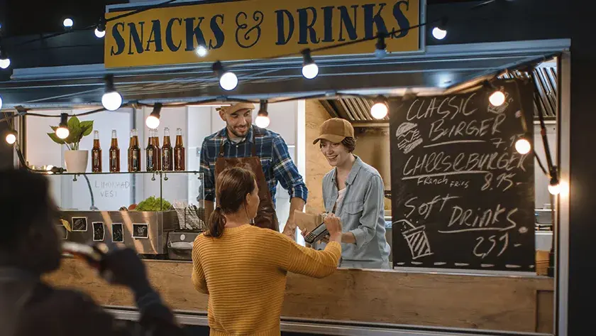 woman paying for or at a food truck