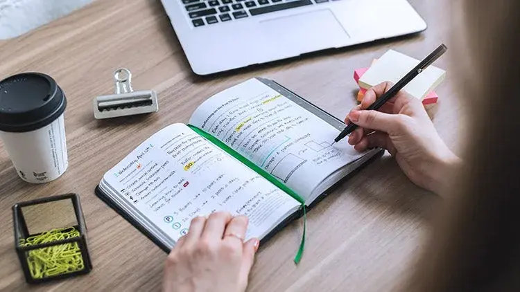 woman writing in a notebook