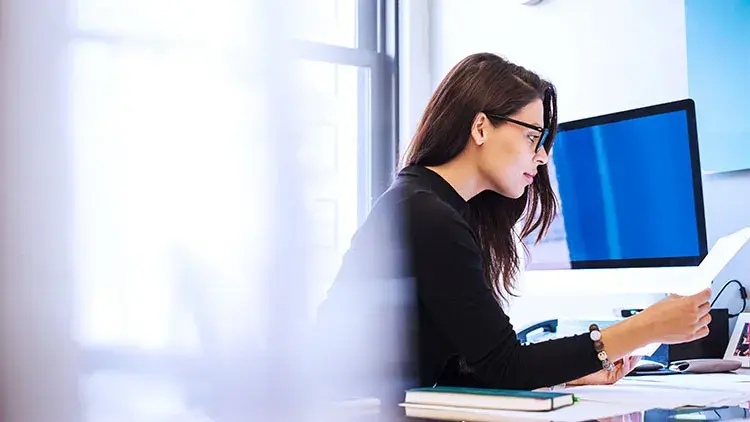 woman-sitting-at-a-desk-in-an-office changing her registered agent 