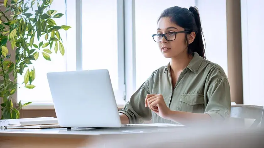 woman-working-on-laptop-next-to-window